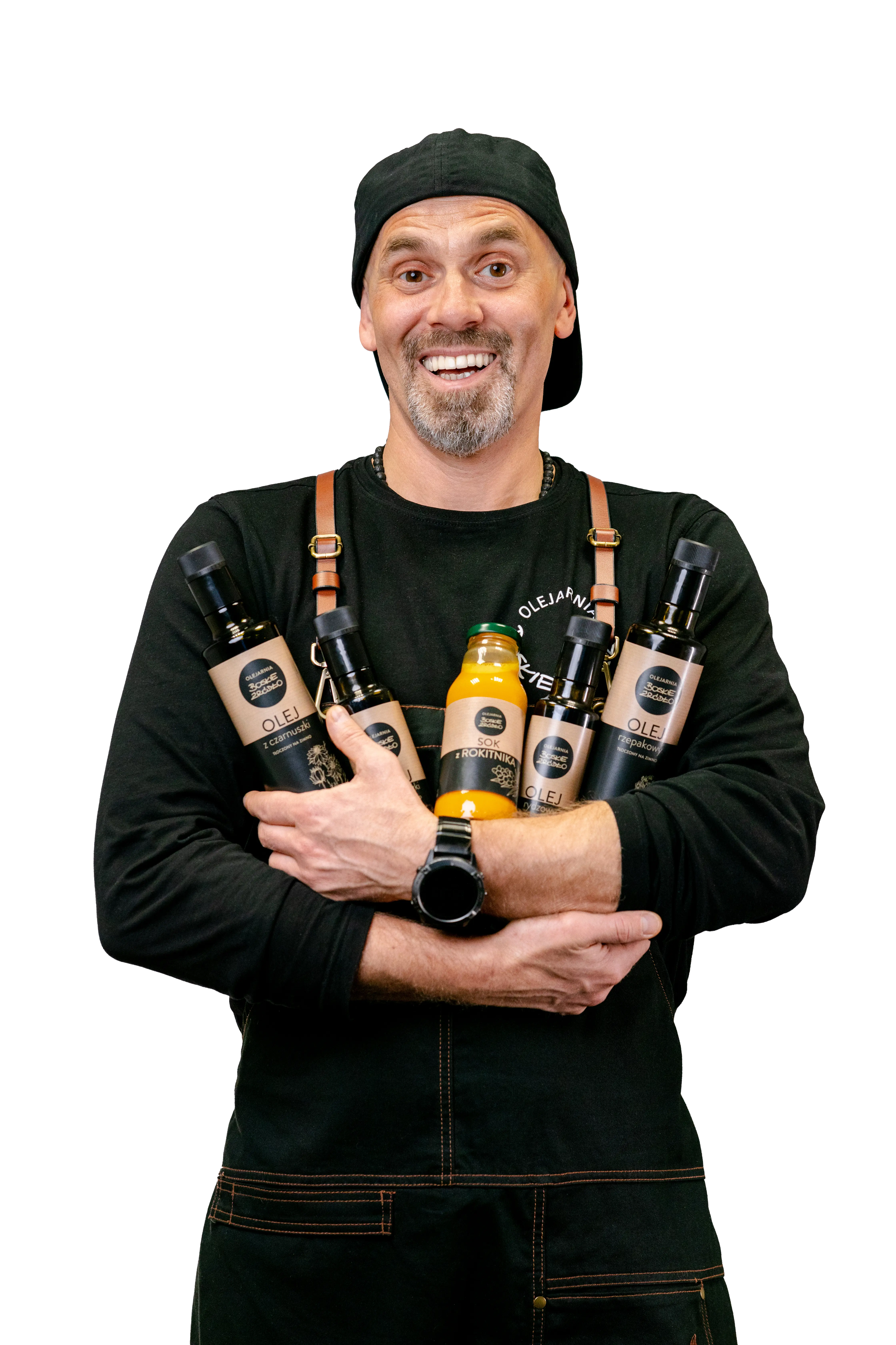 Założyciel Tomasz Dudziński trzymający butelkę oleju.